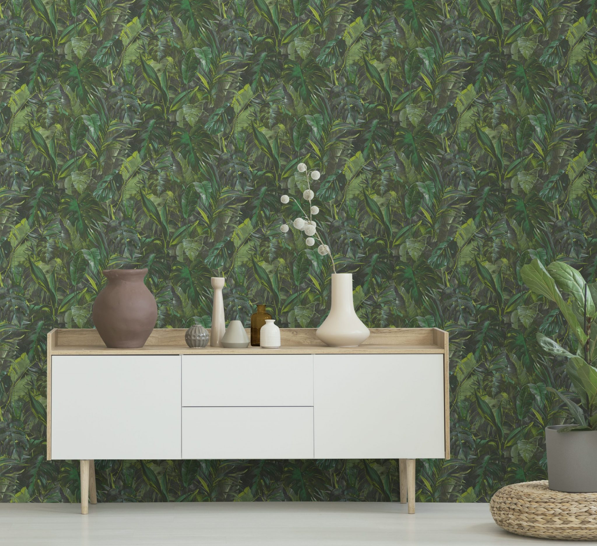 Real photo of a botanic living room interior with burlap artwork on the gray wall and white cupboard surrounded by plants